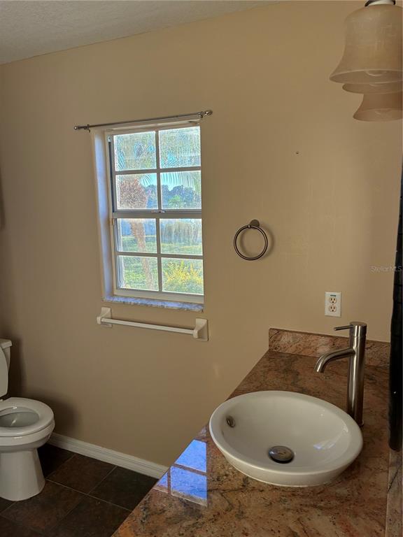 41515 Silver Drive Umatilla, FL 32784 - Photo 25 of 29 a bathroom with a sink and a toilet