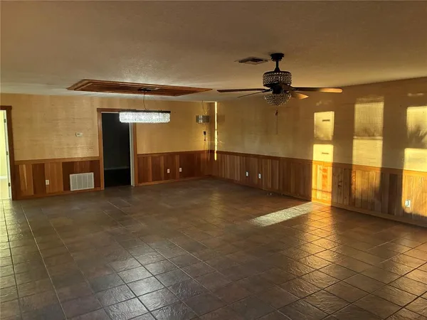 a view of a hallway with wooden shelves