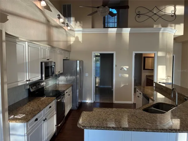 a kitchen with cabinets and stainless steel appliances