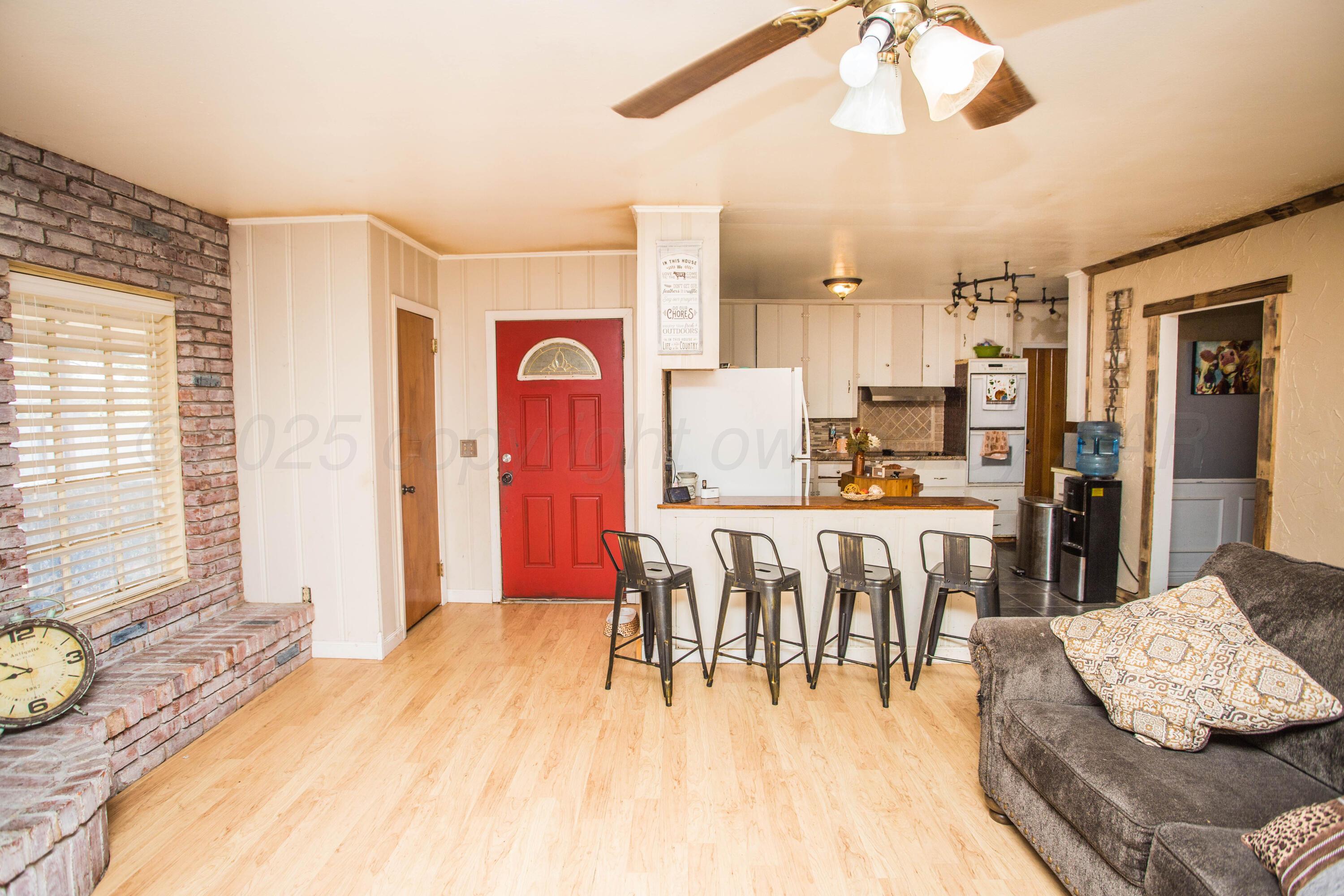 50 Fannin Drive Tulia, TX 79088 - Photo 14 of 40 a dining room with kitchen island stainless steel appliances furniture a large window and kitchen view