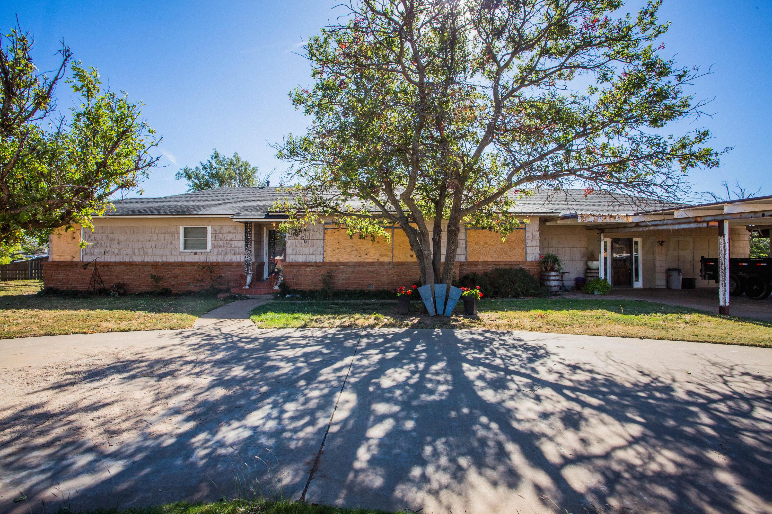 50 Fannin Drive Tulia, TX 79088 - Photo 2 of 40 a view of a house with a yard and large tree