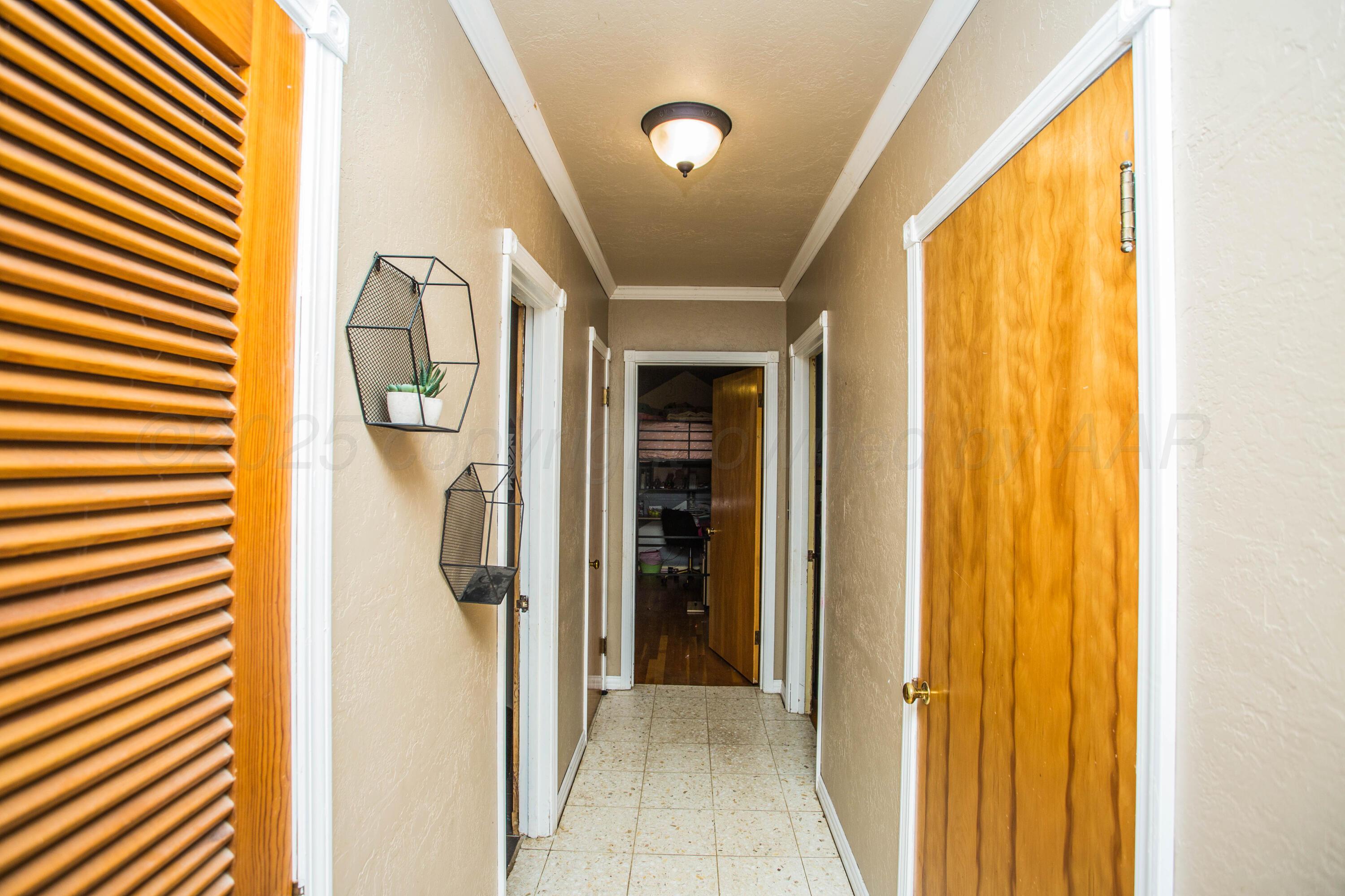 50 Fannin Drive Tulia, TX 79088 - Photo 24 of 40 a view of a hallway with wooden shelves