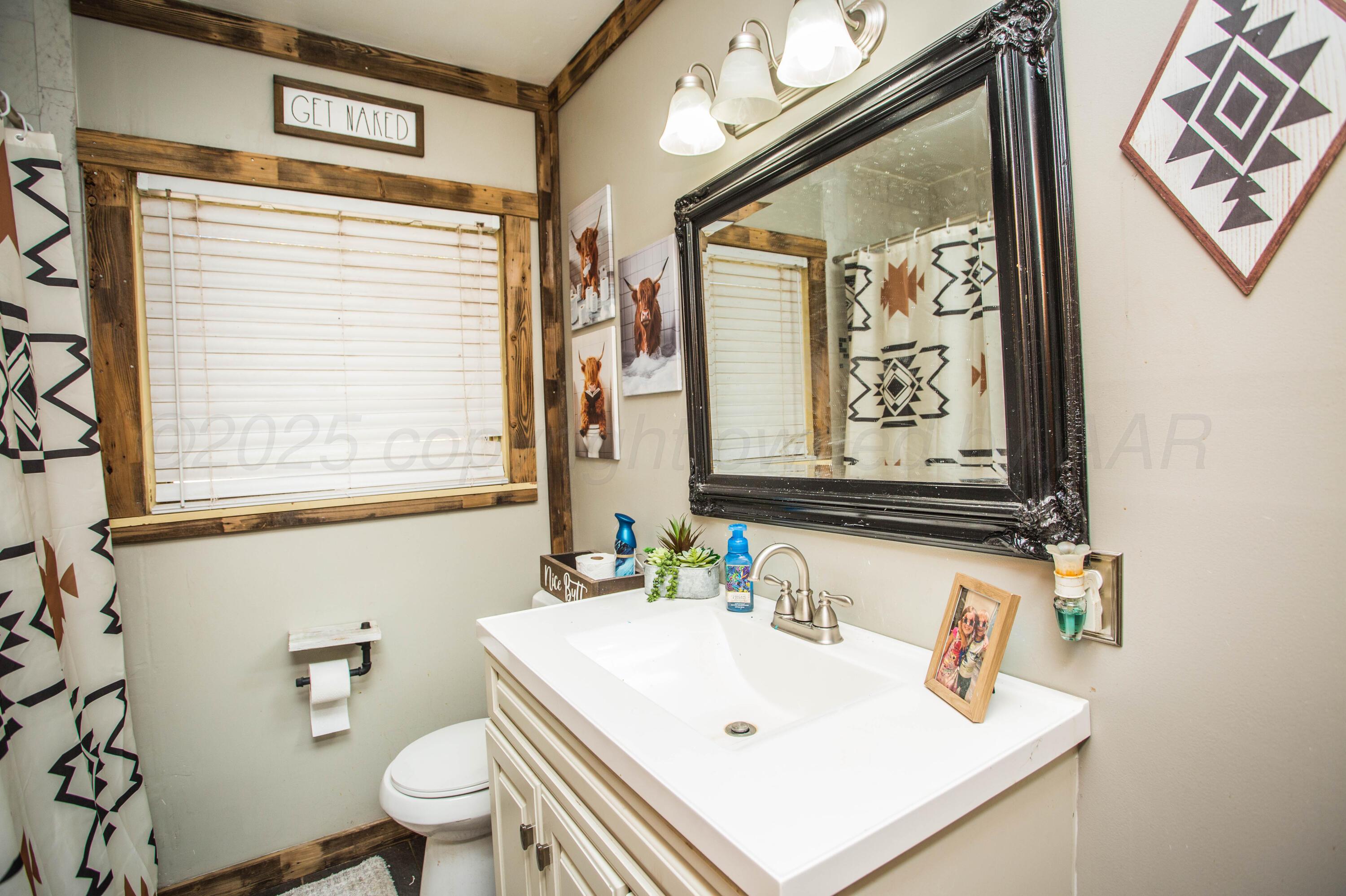 50 Fannin Drive Tulia, TX 79088 - Photo 27 of 40 a bathroom with a sink mirror and a window