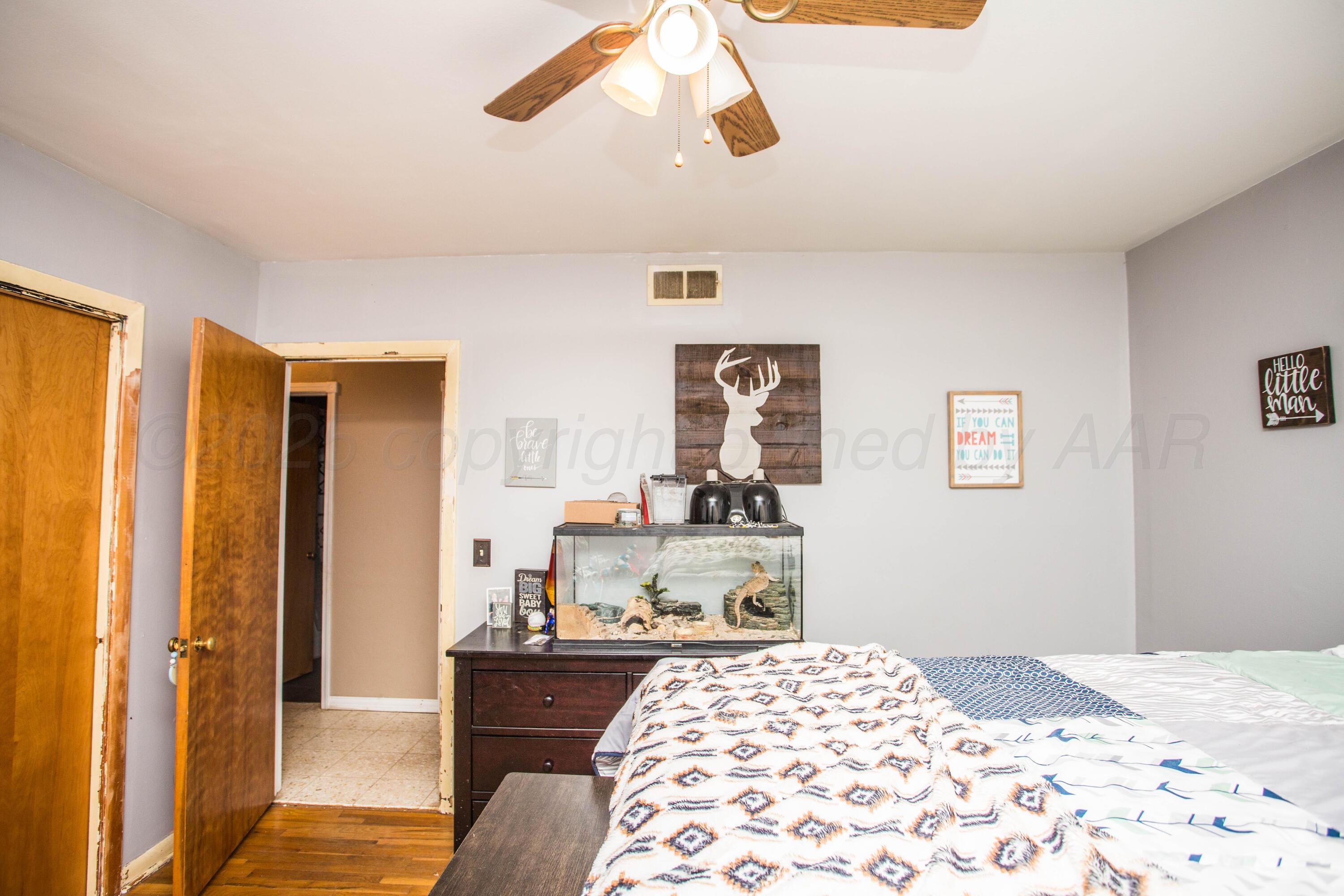 50 Fannin Drive Tulia, TX 79088 - Photo 31 of 40 a bedroom with a bed and a dresser