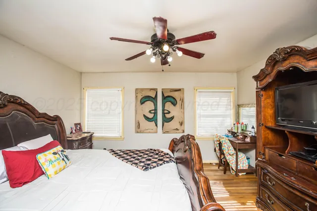 a bedroom with furniture and a flat screen tv