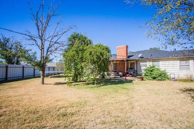 a view of a house with a yard and sitting area
