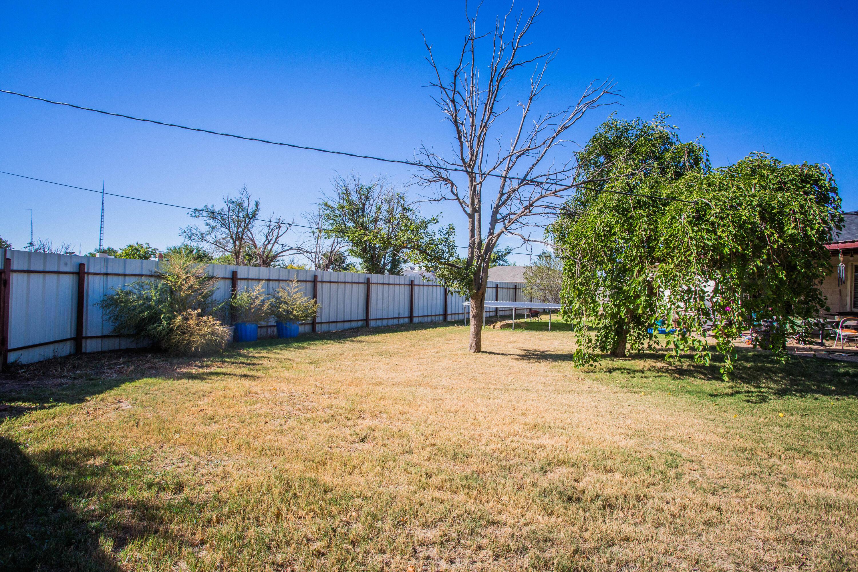 50 Fannin Drive Tulia, TX 79088 - Photo 6 of 40 a backyard of a house with a yard and outdoor seating