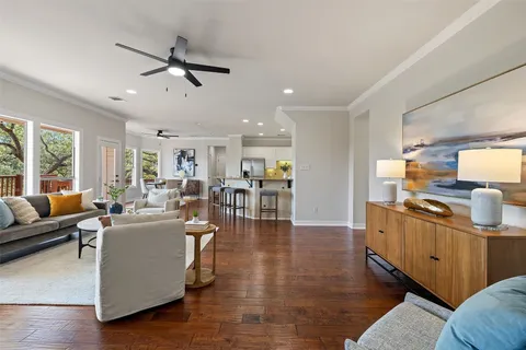 a living room with furniture fireplace and a large window