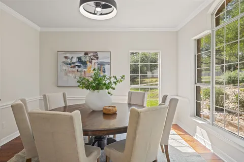 a view of a dining room with furniture window and wooden floor