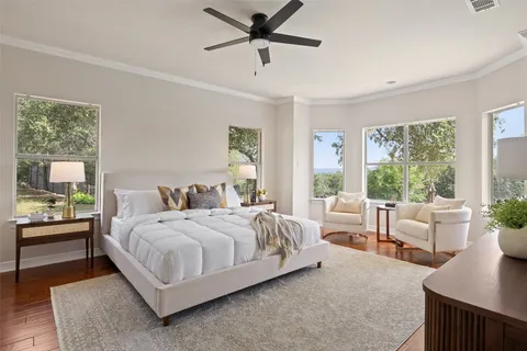 a bedroom with a bed and a large window