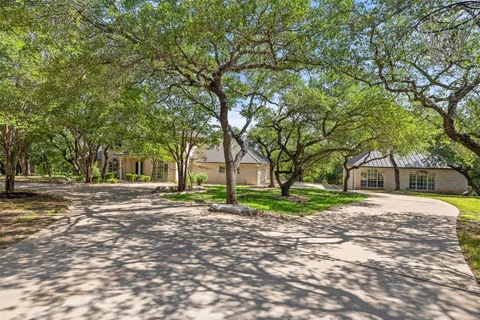 a wooden bench sitting in middle of a yard