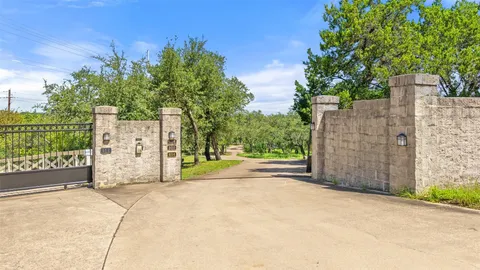 a view of a street with a large trees