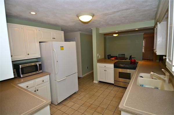 43 Jacob Gates Road Harvard, MA 01451 - Photo 6 of 17 a kitchen with a refrigerator a stove top oven and cabinets