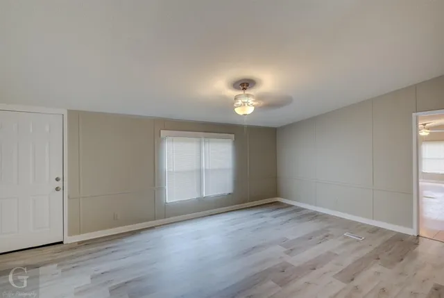 an empty room with wooden floor