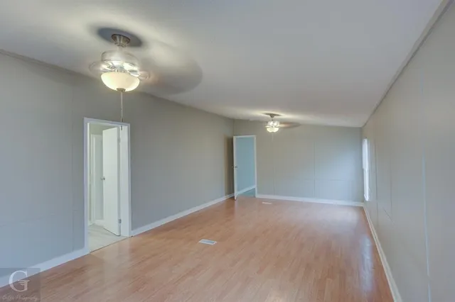 a spacious bathroom with a granite countertop sink and a mirror