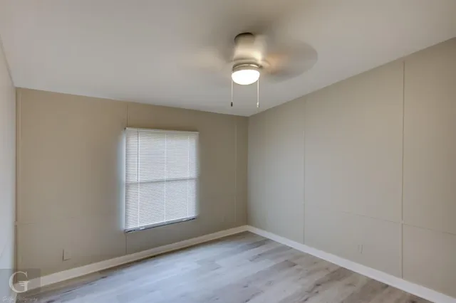 an empty room with wooden floor