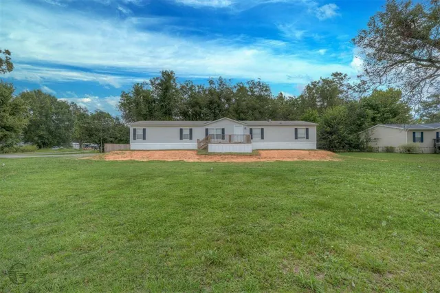 a house view with swimming pool and green space