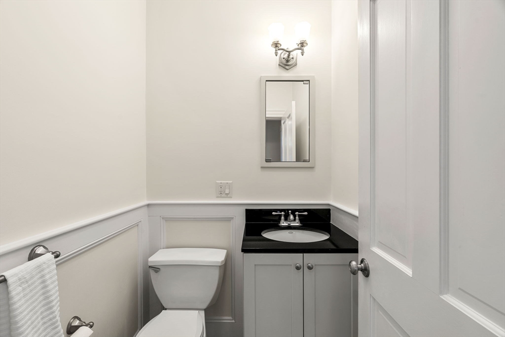 60 Oxford Road Newton, MA 02459 - Photo 11 of 42 a bathroom with a toilet sink and mirror