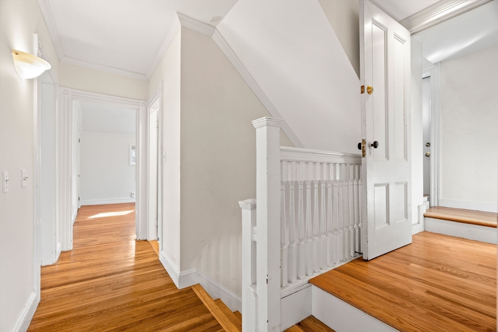 60 Oxford Road Newton, MA 02459 - Photo 19 of 42 a view of a hallway with wooden floor and staircase