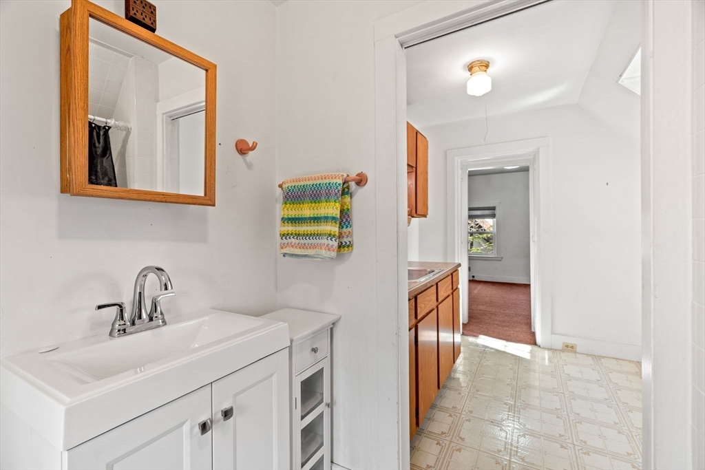 60 Oxford Road Newton, MA 02459 - Photo 29 of 42 a bathroom with a sink and a mirror