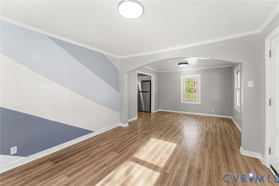 1847 Darbytown Road Henrico, VA 23231 - Photo 3 of 25 a view of an empty room with wooden floor and a window