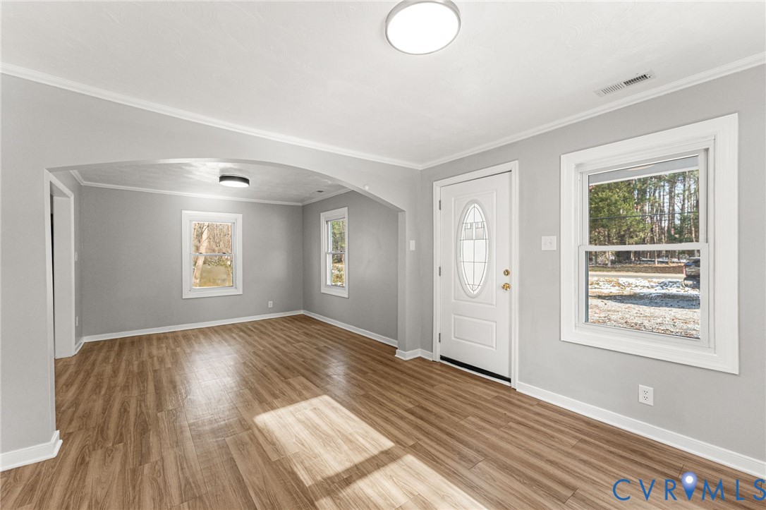 1847 Darbytown Road Henrico, VA 23231 - Photo 4 of 25 a view of an empty room with wooden floor and a window