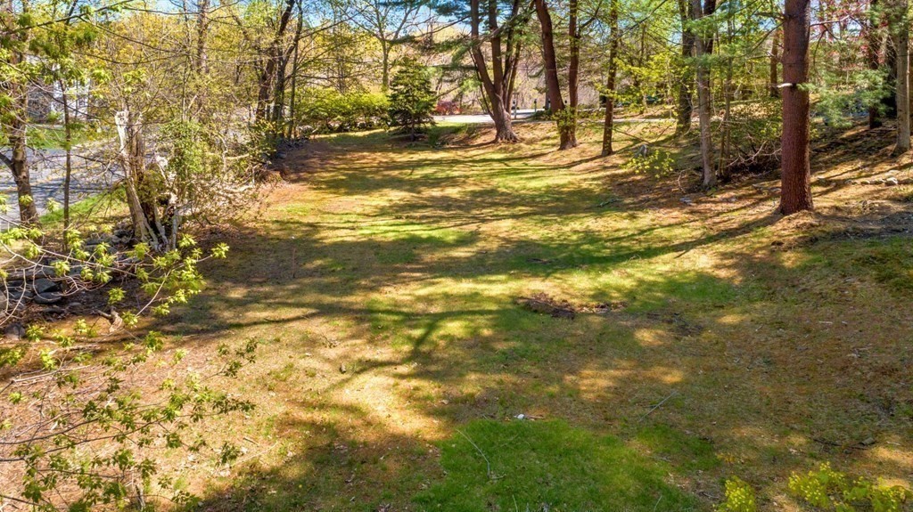 58 Chestnut Street Lynnfield, MA 01940 - Photo 5 of 8 a view of a yard with large trees