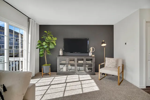 a living room with furniture and kitchen view