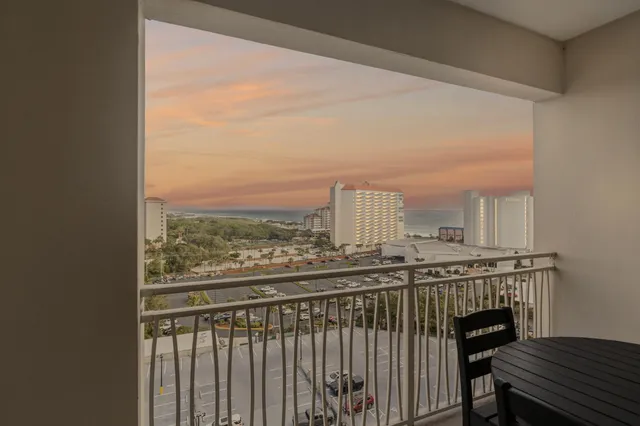 a view of a balcony next to a yard