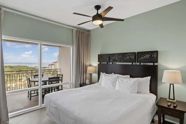 a bedroom with a large bed and a lamp