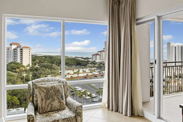 a living room with a large window and a table