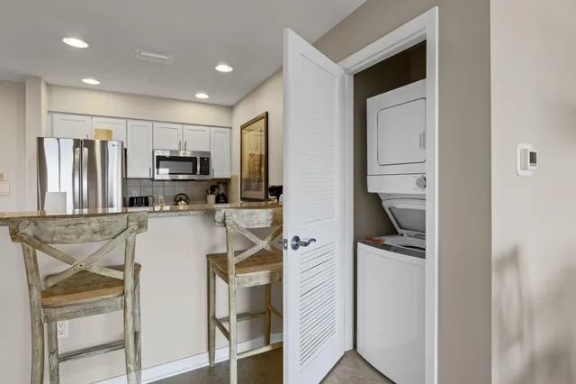 a kitchen with stainless steel appliances a refrigerator and a stove top oven