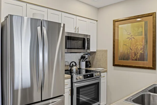 a kitchen with stainless steel appliances a refrigerator a stove a microwave and cabinets