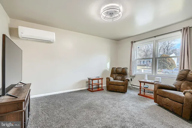 a spacious bedroom with a bed and a flat screen tv