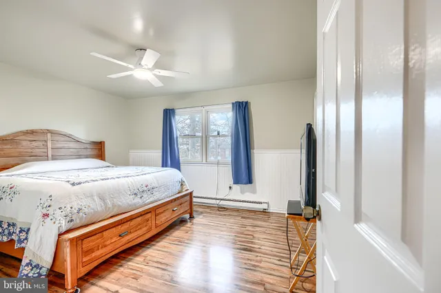 a view of a room with wooden floor and a window