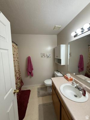 641 East Greystone Way Tooele, UT 84074 - Photo 11 of 30 Bathroom featuring a single vanity with a laminate countertop, white basin sink, and chrome faucet
