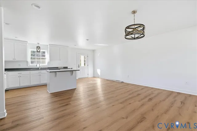 a view of kitchen with wooden floor and electronic appliances
