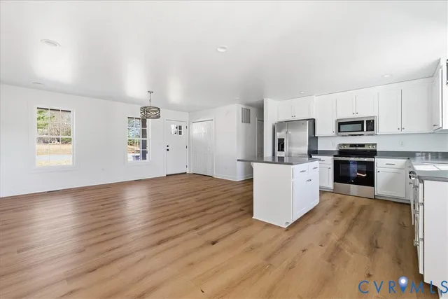 a kitchen with stainless steel appliances a refrigerator and a stove top oven