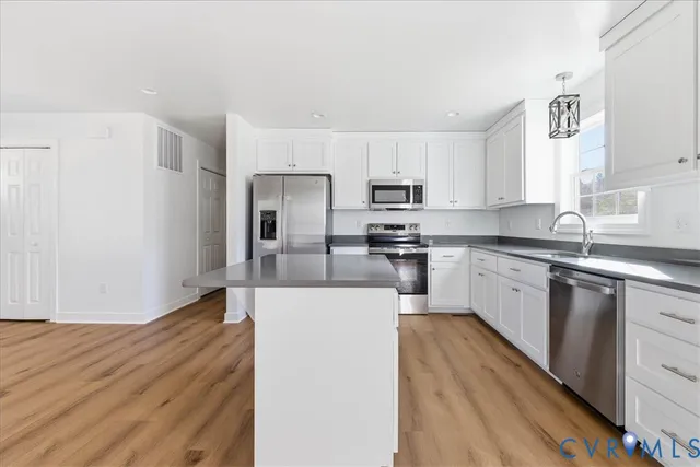 a kitchen with wooden cabinets and stainless steel appliances