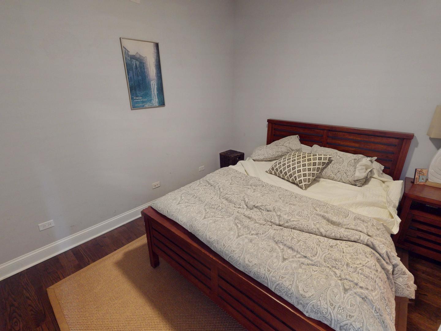 31 North Morgan Street, Unit 2 Chicago, IL 60607 - Photo 13 of 17 a bedroom with a bed and a lamp on dresser