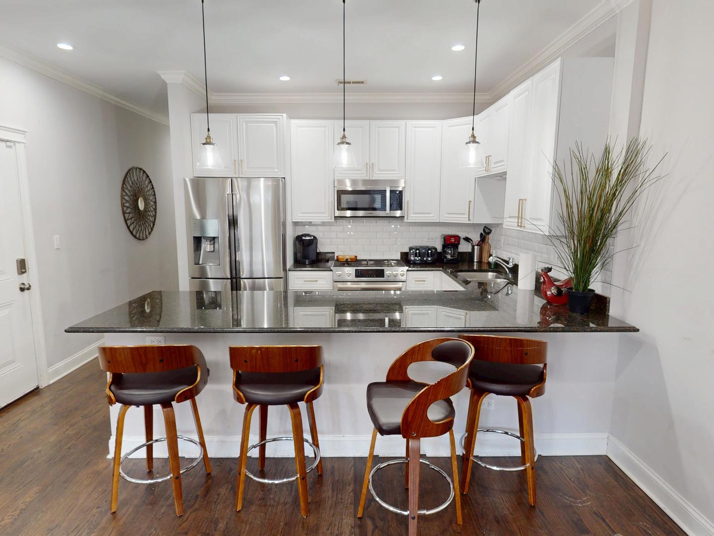 31 North Morgan Street, Unit 2 Chicago, IL 60607 - Photo 2 of 17 a kitchen with granite countertop a table chairs stove and refrigerator