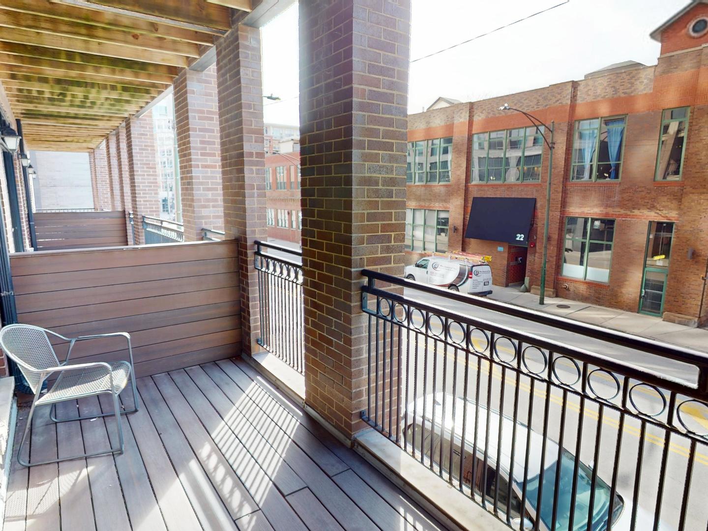 31 North Morgan Street, Unit 2 Chicago, IL 60607 - Photo 6 of 17 a view of a balcony with furniture and wooden floor