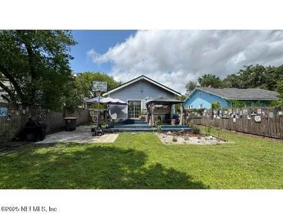 a aerial view of a house with swimming pool and a yard