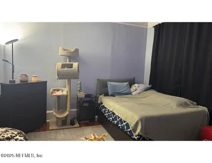 a bedroom with a bed and a night stand