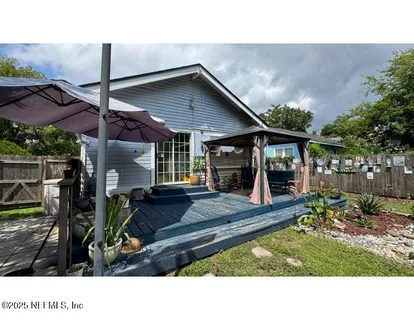 a backyard of a house with table and chairs