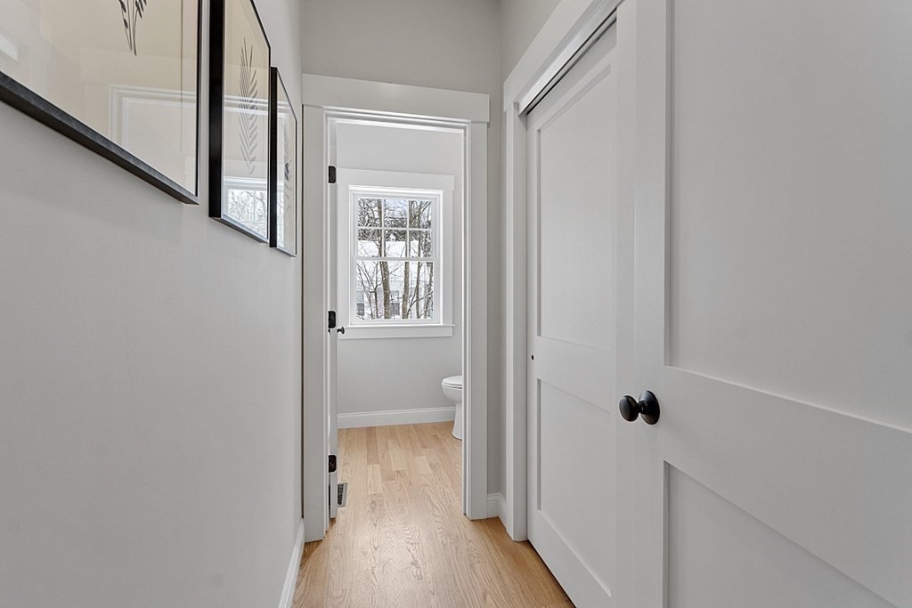 145 New Estate Road Littleton, MA 01460 - Photo 19 of 41 a view of a hallway with wooden floor and a bathroom