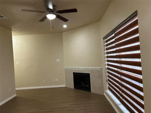 wooden floor in an empty room with a fireplace