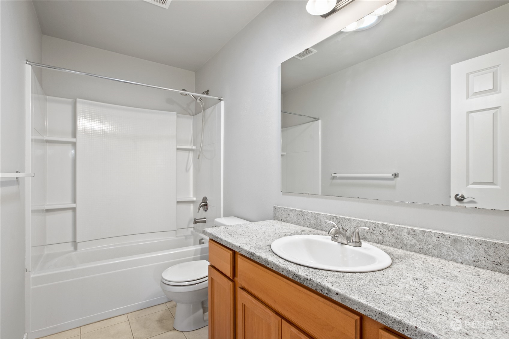 20734 76th Avenue West, Unit D Edmonds, WA 98026 - Photo 25 of 32 a bathroom with a granite countertop sink toilet mirror and shower