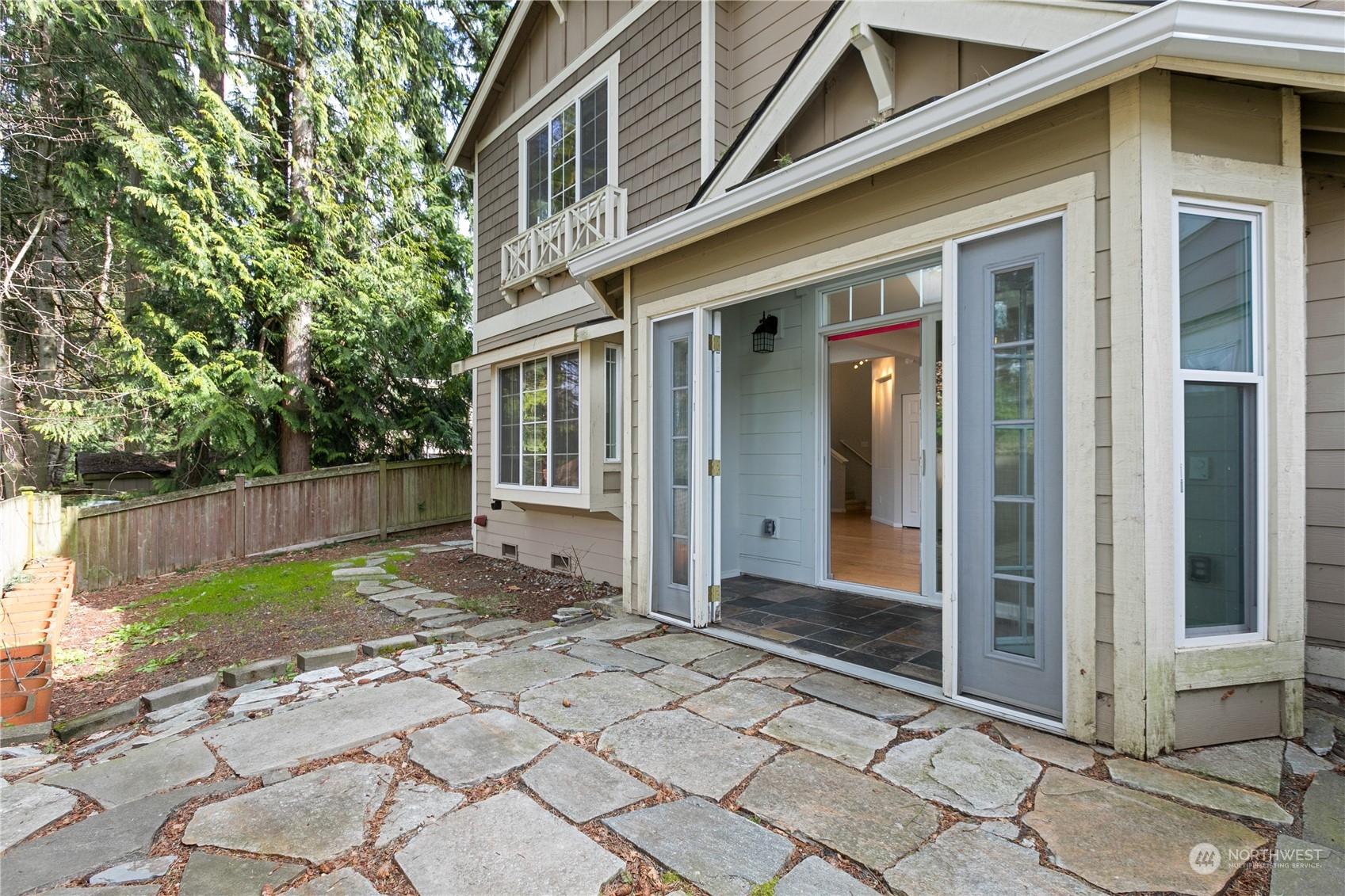 20734 76th Avenue West, Unit D Edmonds, WA 98026 - Photo 27 of 32 a view of a brick house with many windows next to a yard