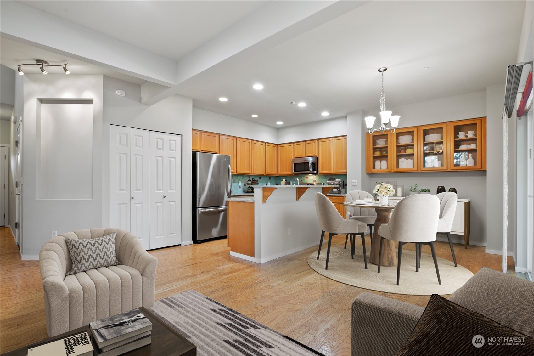 20734 76th Avenue West, Unit D Edmonds, WA 98026 - Photo 7 of 32 a living room with furniture a chandelier and kitchen view
